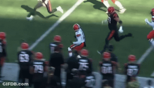 A Football Player Is Jumping In The Air During A Game While Wearing A Number 71 Jersey GIF