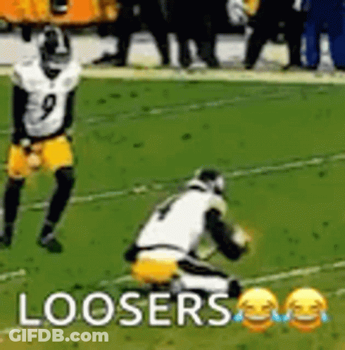 A Football Player Is Kneeling Down On The Field While Another Player Is Running . GIF