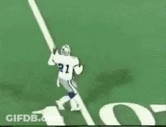 A Football Player Is Running On A Field In Front Of A Huge Nfl Logo GIF
