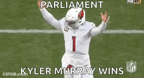 A Football Player Is Running On A Field While Wearing A White Jersey And A Helmet . GIF