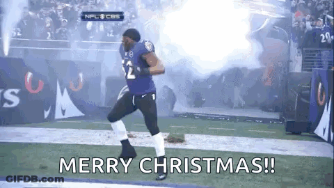 A Football Player Is Running On A Field With Smoke Coming Out Of The Stands And The Words `` Merry Christmas ! '' GIF