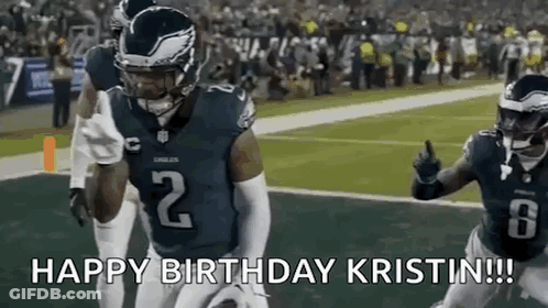 A Football Player Is Running With The Ball On A Field While Giving A Thumbs Up . GIF