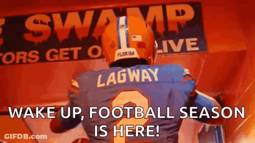 A Football Player Is Standing In Front Of A Sign That Says Wake Up , Football Season Is Here ! GIF