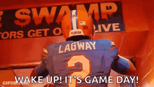 A Football Player Is Standing In Front Of A Sign That Says `` Wake Up ! It 'S Game Day '' . GIF