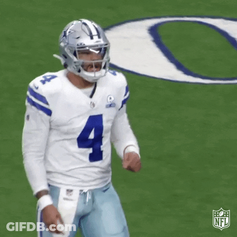 A Football Player Is Standing On A Field Wearing A Helmet And A Number 4 Jersey . GIF