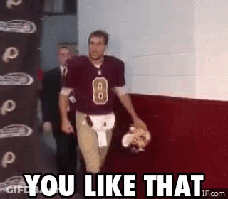A Football Player Is Walking Down A Hallway With The Words `` You Like That '' Written On It . GIF
