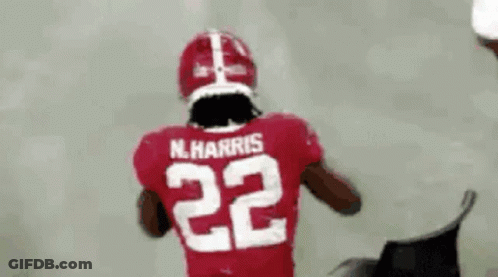 A Football Player Is Wearing A Red Jersey With The Number 22 On The Back . GIF