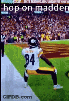 A Football Player Kneeling On The Field With The Number 84 On His Jersey . GIF