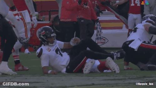 A Football Player Laying On The Field With The Number 4 On The Back Of His Jersey GIF