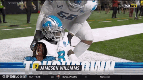 A Football Player Named Jameson Williams Is Laying On The Ground GIF