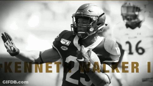 A Football Player Named Kennet Walker Is Running With The Ball GIF