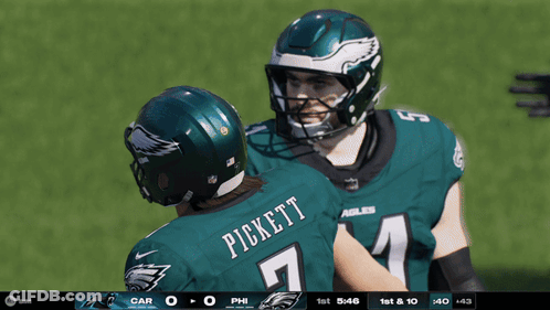 A Football Player Named Pickett Is Hugging Another Player On The Field GIF
