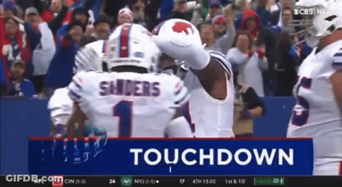 A Football Player Named Sanders Is Celebrating A Touchdown With His Teammates GIF