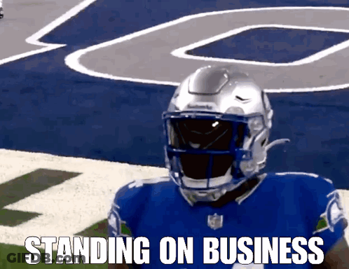 A Football Player Standing On A Field With The Words Standing On Business Written Below Him GIF