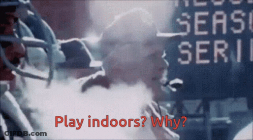 A Football Player Stands In Front Of A Scoreboard That Says " Play Indoors " GIF