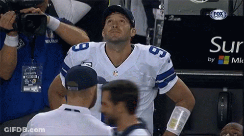 A Football Player Stands In Front Of A Sign That Says Sur By Mic GIF
