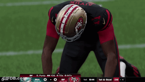 A Football Player Wearing A 49Ers Helmet Stands On A Field GIF