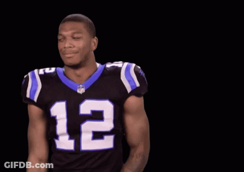 A Football Player Wearing A Black And Blue Jersey With The Number 12 On It GIF
