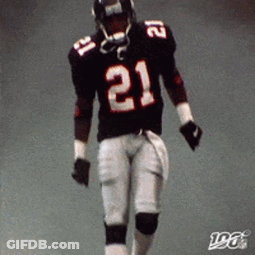 A Football Player Wearing A Black Jersey With The Number 21 On It GIF