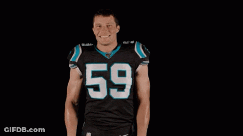 A Football Player Wearing A Black Jersey With The Number 59 On It Is Standing In Front Of A Black Background With His Ha GIF