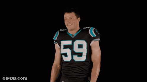 A Football Player Wearing A Black Jersey With The Number 59 On It Is Standing With His Arms Outstretched . GIF