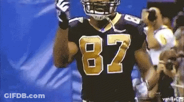 A Football Player Wearing A Black Jersey With The Number 82 On It GIF