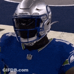 A Football Player Wearing A Blue Jersey And A Helmet GIF