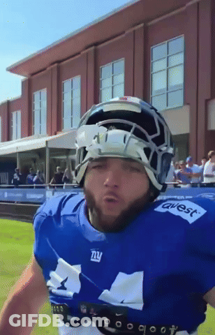A Football Player Wearing A Blue Jersey That Says Ny GIF
