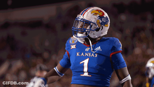 A Football Player Wearing A Blue Jersey With Kansas On It GIF