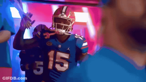 A Football Player Wearing A Blue Jersey With The Number 15 GIF