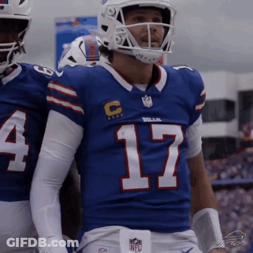 A Football Player Wearing A Blue Jersey With The Number 17 On The Front GIF