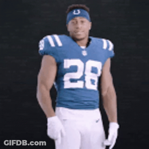 A Football Player Wearing A Blue Jersey With The Number 28 GIF