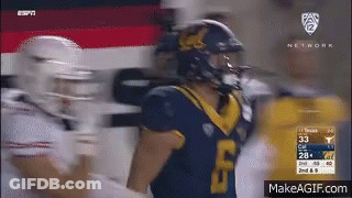 A Football Player Wearing A Blue Jersey With The Number 33 On It GIF