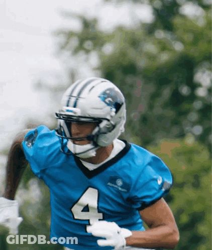 A Football Player Wearing A Blue Jersey With The Number 4 GIF