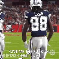 A Football Player Wearing A Blue Jersey With The Number 88 On It Is Running On The Field . GIF