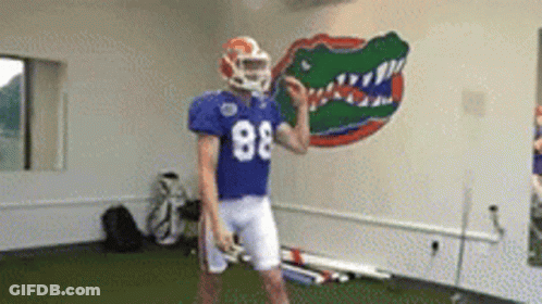 A Football Player Wearing A Blue Jersey With The Number 88 GIF