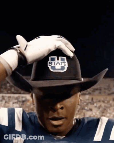 A Football Player Wearing A Cowboy Hat That Says State GIF