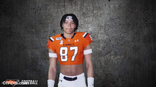 A Football Player Wearing A Crop Top With The Number 87 On It GIF