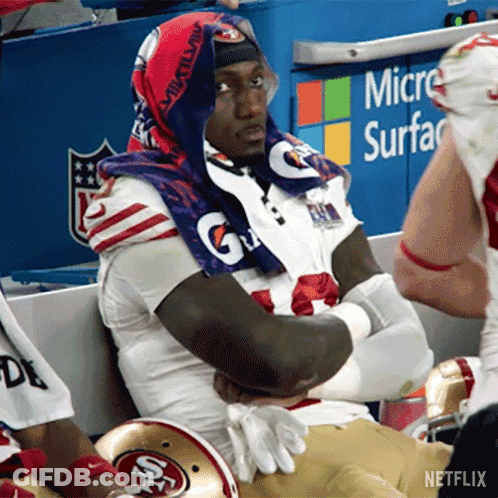 A Football Player Wearing A Gatorade Towel Around His Neck GIF