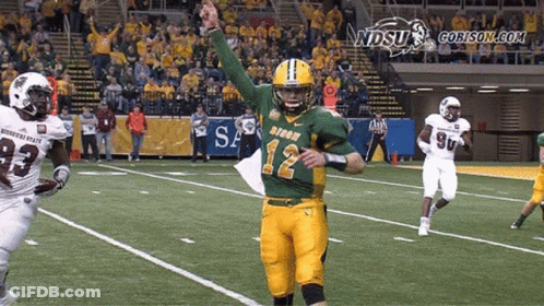 A Football Player Wearing A Green And Yellow Jersey With The Number 12 On It GIF