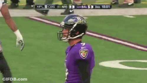 A Football Player Wearing A Helmet And A Ravens Jersey Is On The Field GIF