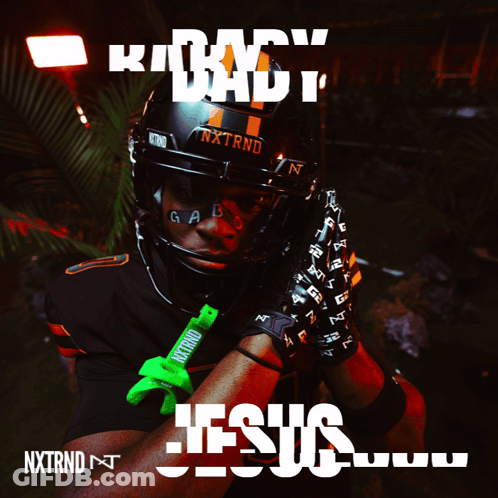 A Football Player Wearing A Helmet And Gloves With The Word Jesus On It GIF