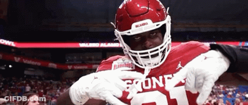 A Football Player Wearing A Helmet And Number 21 Jersey GIF