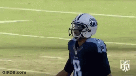 A Football Player Wearing A Helmet And Number 8 Jersey Is Standing On The Field . GIF