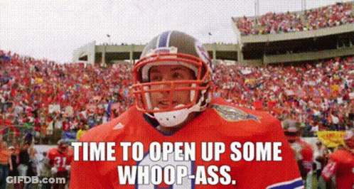 A Football Player Wearing A Helmet Is Standing In Front Of A Crowd Of People On A Field . GIF