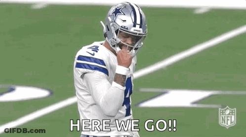 A Football Player Wearing A Helmet Is Standing On A Field . GIF