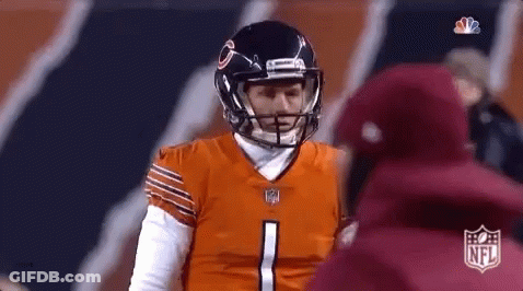 A Football Player Wearing A Helmet Is Talking To A Coach . GIF