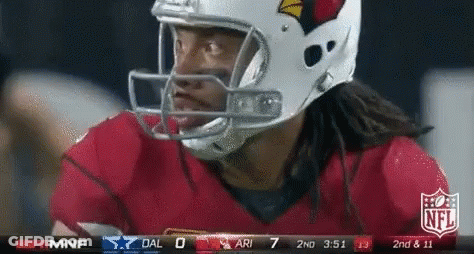 A Football Player Wearing A Helmet Looks At The Scoreboard GIF
