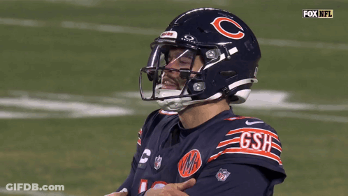 A Football Player Wearing A Helmet That Says Gsh GIF
