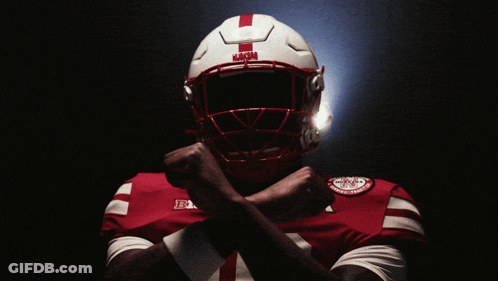 A Football Player Wearing A Helmet That Says ' Nebraska ' On The Front GIF